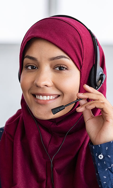 A woman wearing a headset and smiling