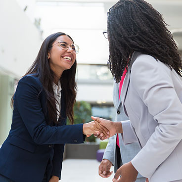 a young professional shaking the hand of another person