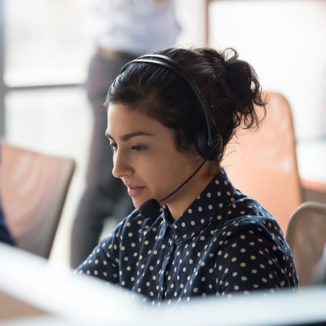 a woman working with a headset on