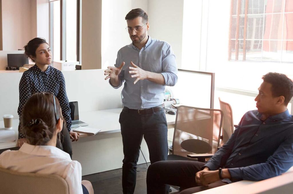 employees having a discussion in an office setting